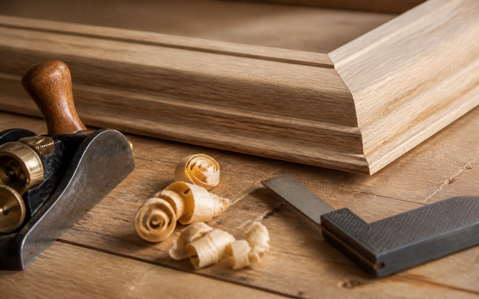Carpentry hand tools beside fitted wood trim
